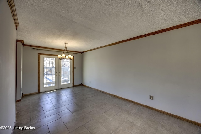 spare room featuring baseboards, a chandelier, crown molding, and french doors