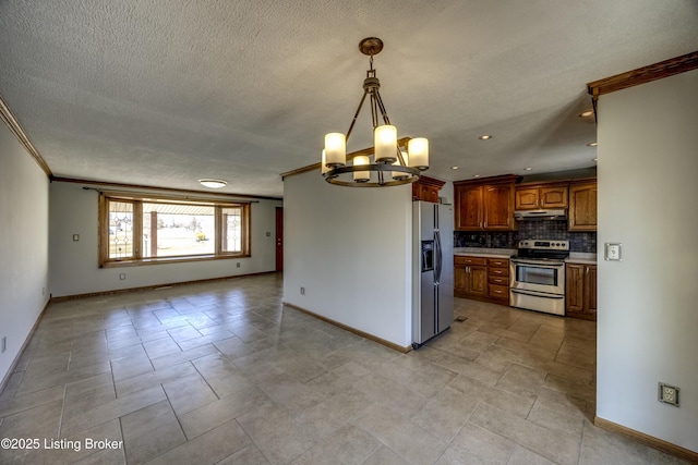 kitchen featuring appliances with stainless steel finishes, ornamental molding, light countertops, under cabinet range hood, and backsplash