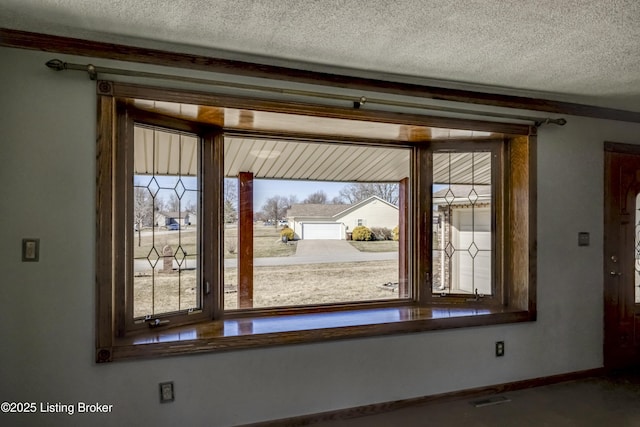 details with visible vents, a textured ceiling, and baseboards