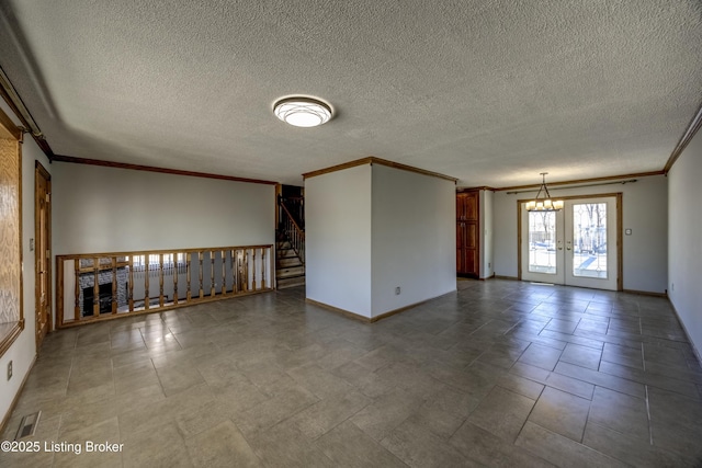 unfurnished living room with visible vents, baseboards, crown molding, and french doors