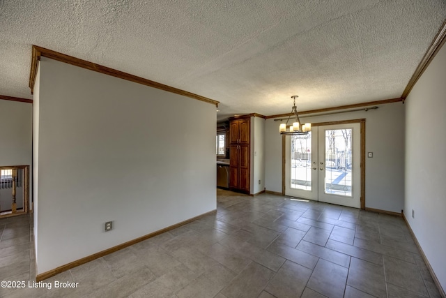 unfurnished room featuring baseboards, a chandelier, crown molding, and french doors