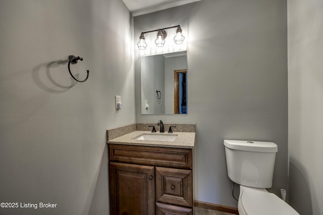 bathroom featuring toilet and vanity