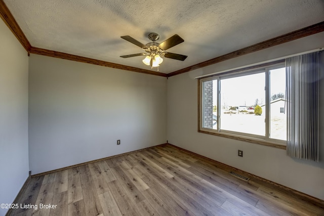 unfurnished room featuring light wood-type flooring, crown molding, ceiling fan, and a textured ceiling