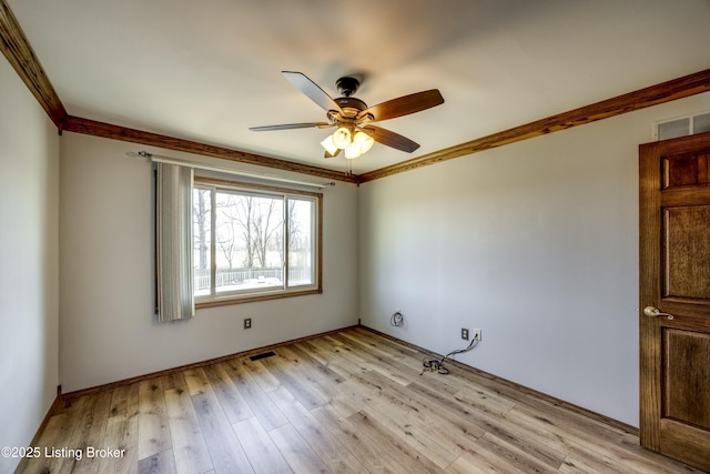 unfurnished room featuring ornamental molding, visible vents, ceiling fan, and light wood finished floors