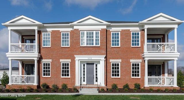 view of front of property with a balcony and brick siding