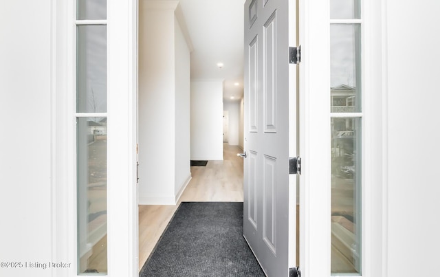 hallway featuring wood finished floors and recessed lighting