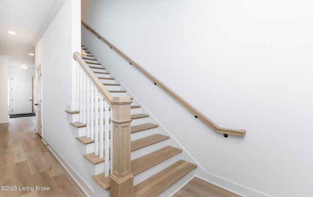 stairs featuring recessed lighting, baseboards, and wood finished floors