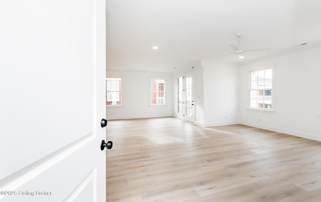 spare room featuring recessed lighting, baseboards, and light wood finished floors