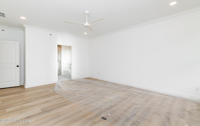 empty room with recessed lighting, visible vents, baseboards, light wood-style floors, and crown molding