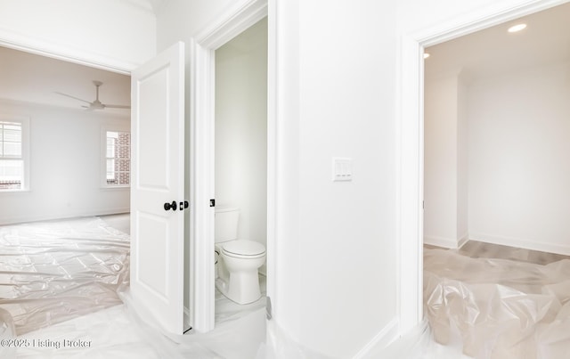 bathroom featuring a ceiling fan and toilet