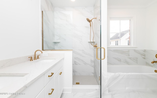 full bathroom featuring a bathing tub, a sink, ornamental molding, a marble finish shower, and double vanity