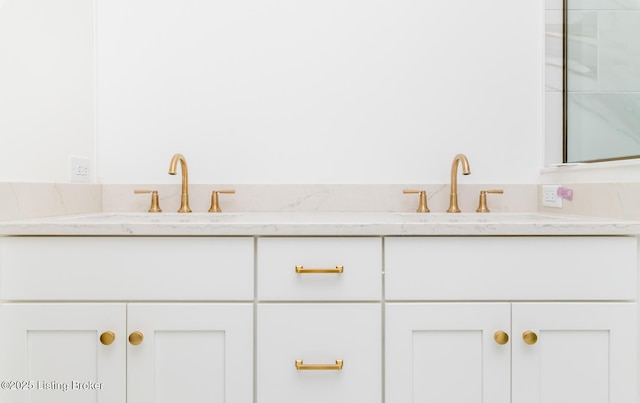 bathroom with a sink and double vanity