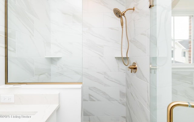 full bathroom with a shower stall, a wealth of natural light, and vanity