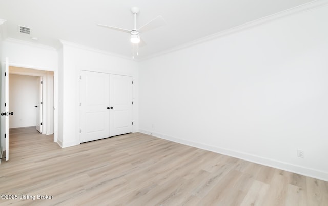 unfurnished bedroom featuring ornamental molding, light wood-style flooring, and visible vents