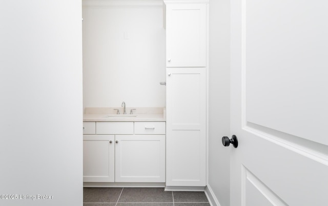 bathroom featuring tile patterned flooring, baseboards, and vanity