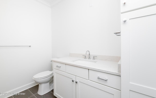 bathroom featuring baseboards, toilet, ornamental molding, tile patterned flooring, and vanity