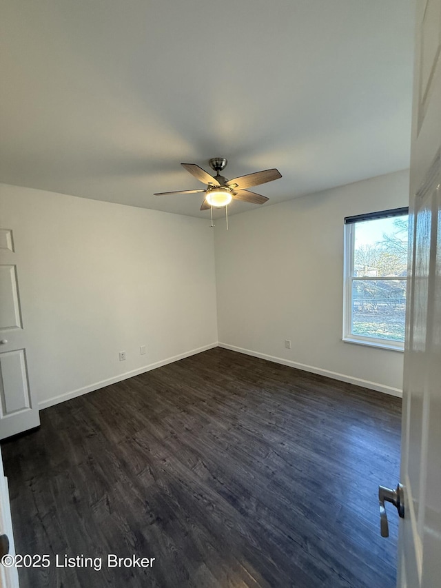 unfurnished room with dark wood finished floors, baseboards, and ceiling fan