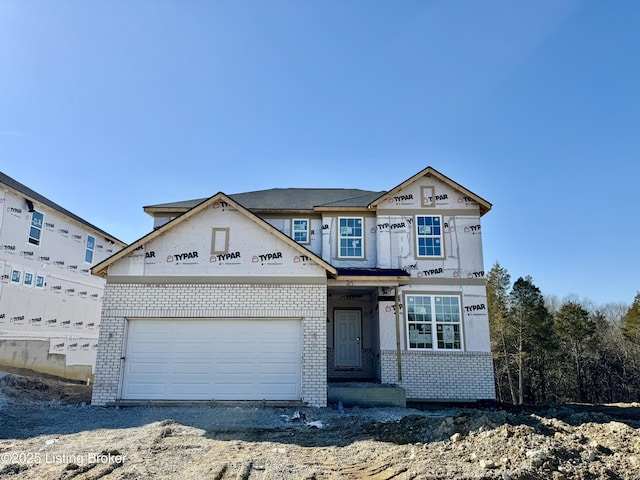 unfinished property featuring brick siding and an attached garage