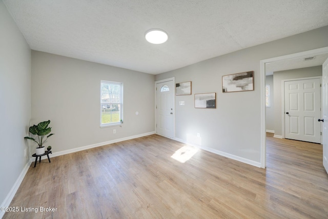 empty room featuring light wood-style flooring and baseboards