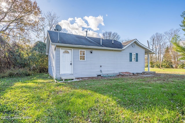 rear view of house with a lawn