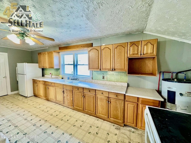 kitchen with white appliances, water heater, a sink, and light floors