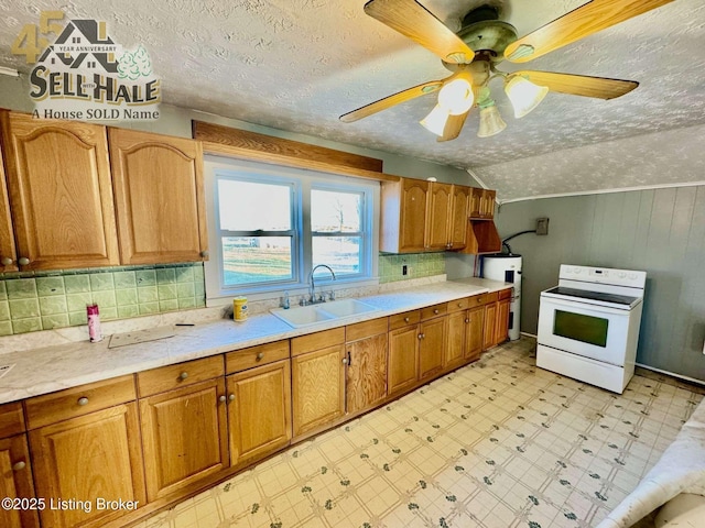 kitchen with white range with electric stovetop, a sink, light countertops, light floors, and backsplash