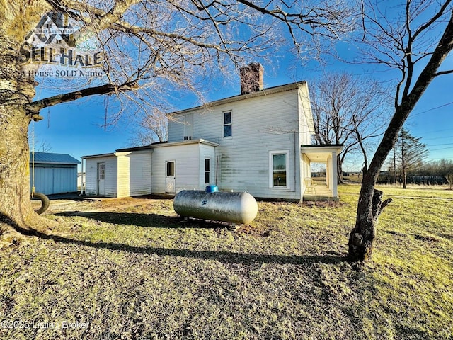 rear view of house featuring a chimney