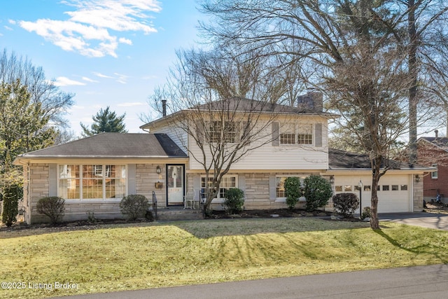 tri-level home featuring an attached garage, stone siding, driveway, a chimney, and a front yard