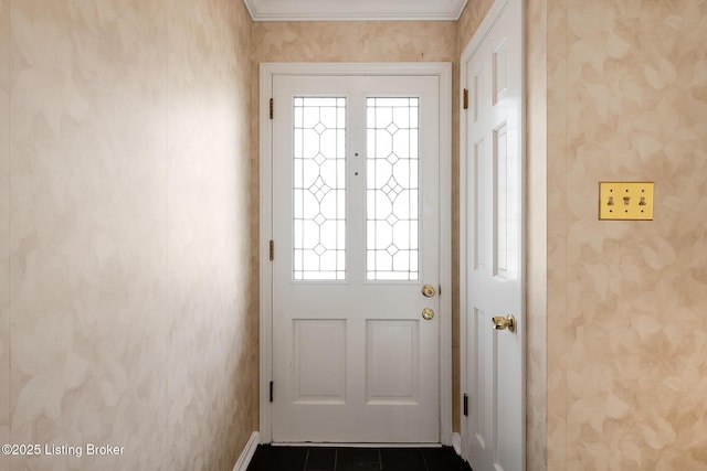 doorway with wallpapered walls, baseboards, and dark tile patterned flooring