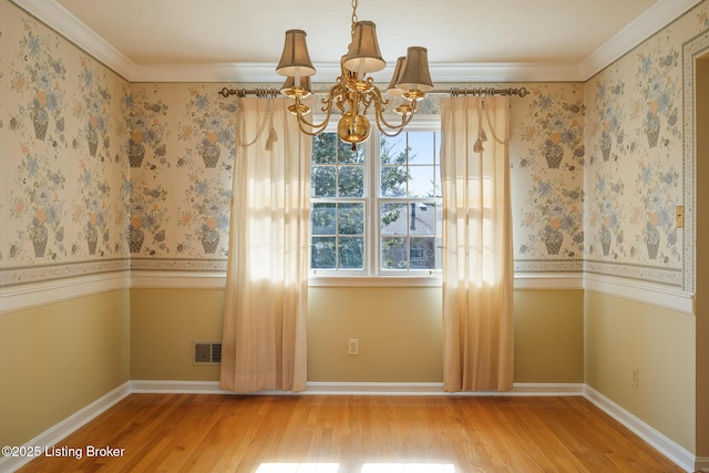 unfurnished dining area with a chandelier, wood finished floors, visible vents, and wallpapered walls