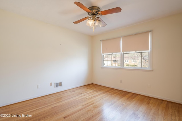 unfurnished room featuring visible vents, ceiling fan, baseboards, and wood finished floors