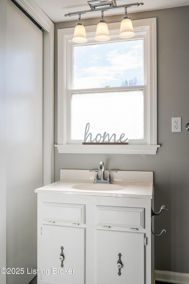 bathroom featuring a wealth of natural light and vanity