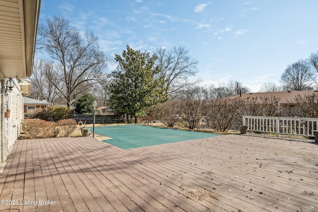 view of pool featuring fence and a wooden deck