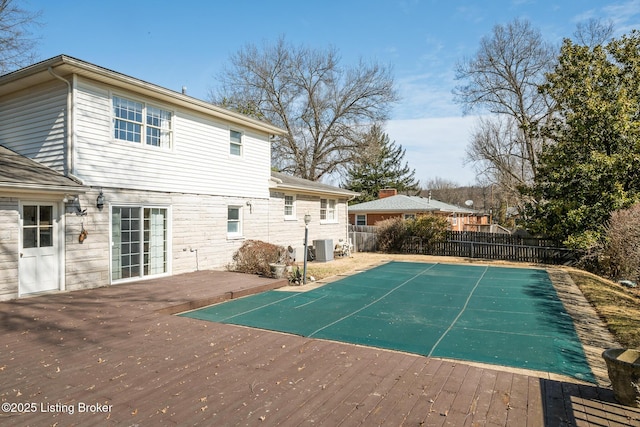 exterior space with central AC, fence, and a deck