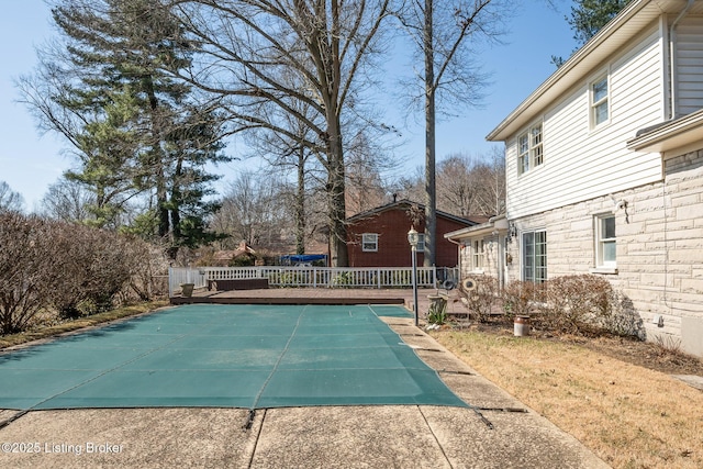 view of swimming pool featuring a wooden deck