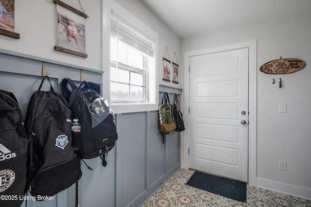 mudroom with tile patterned floors and baseboards