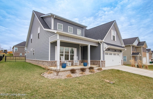 view of front of house with brick siding, an attached garage, a front yard, covered porch, and driveway