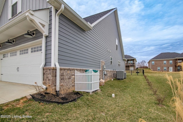 view of property exterior featuring cooling unit, brick siding, a garage, a lawn, and board and batten siding