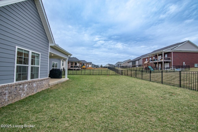 view of yard featuring a residential view and a fenced backyard