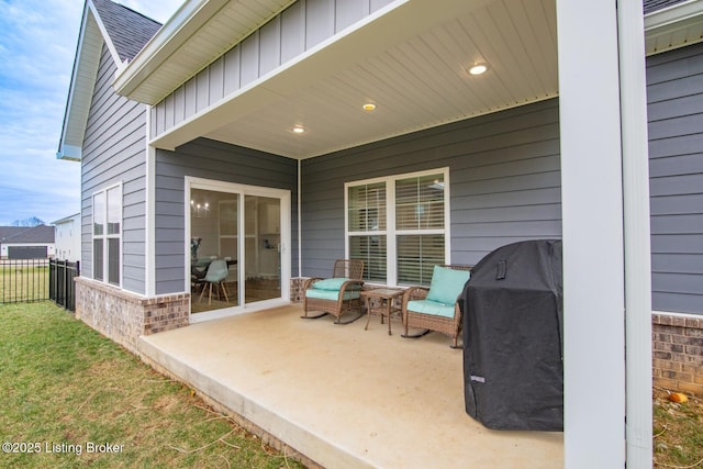 view of patio featuring area for grilling and fence