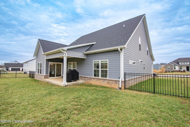 back of house with a patio, fence, a yard, a shingled roof, and brick siding