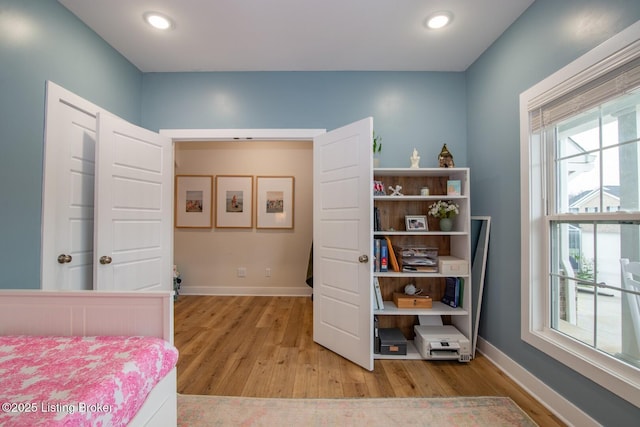 bedroom with recessed lighting, baseboards, and light wood-type flooring