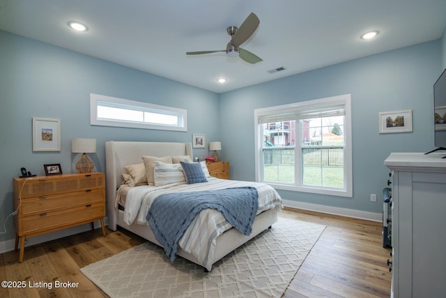 bedroom featuring multiple windows, visible vents, and light wood finished floors