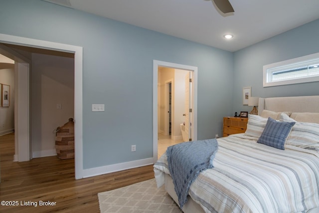 bedroom featuring recessed lighting, ensuite bath, baseboards, and wood finished floors