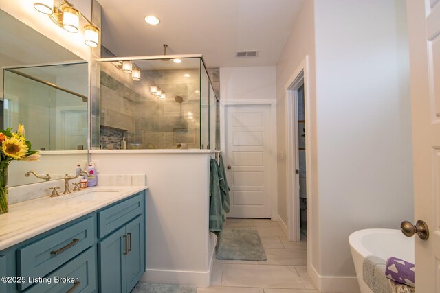 bathroom with visible vents, a shower stall, a freestanding bath, recessed lighting, and vanity