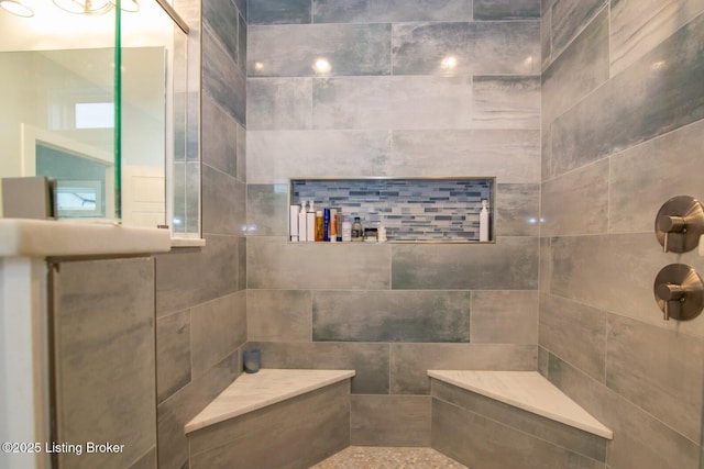 bathroom with tiled shower