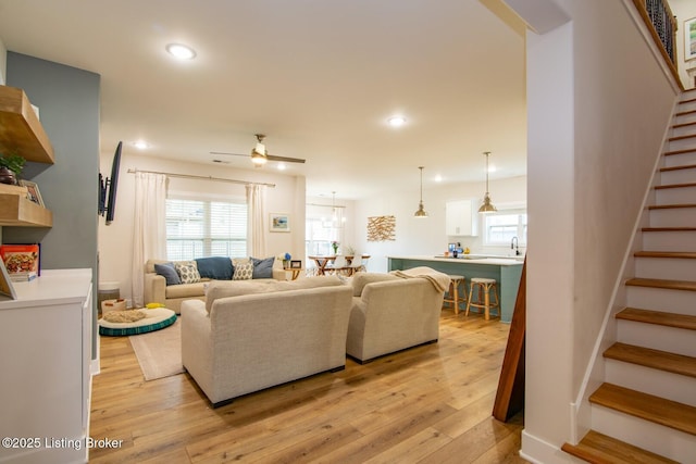 living room with recessed lighting, stairway, light wood-style floors, and a ceiling fan