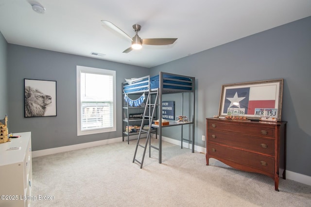 bedroom with visible vents, a ceiling fan, baseboards, and light carpet