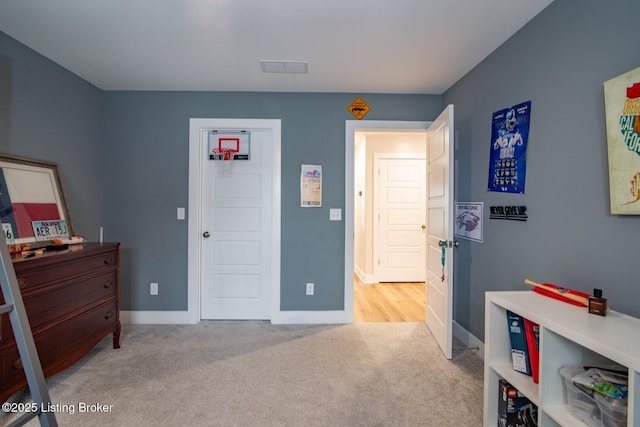 carpeted bedroom with visible vents and baseboards