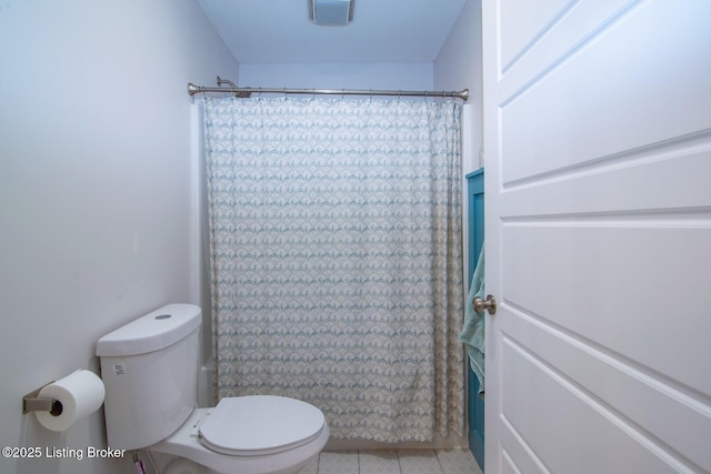 bathroom with tile patterned flooring, visible vents, toilet, and a shower with shower curtain